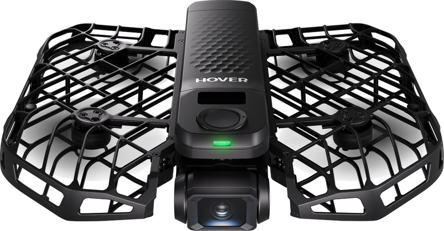 Un drone Hover nero con protezioni per eliche e fotocamera. LED verde acceso.