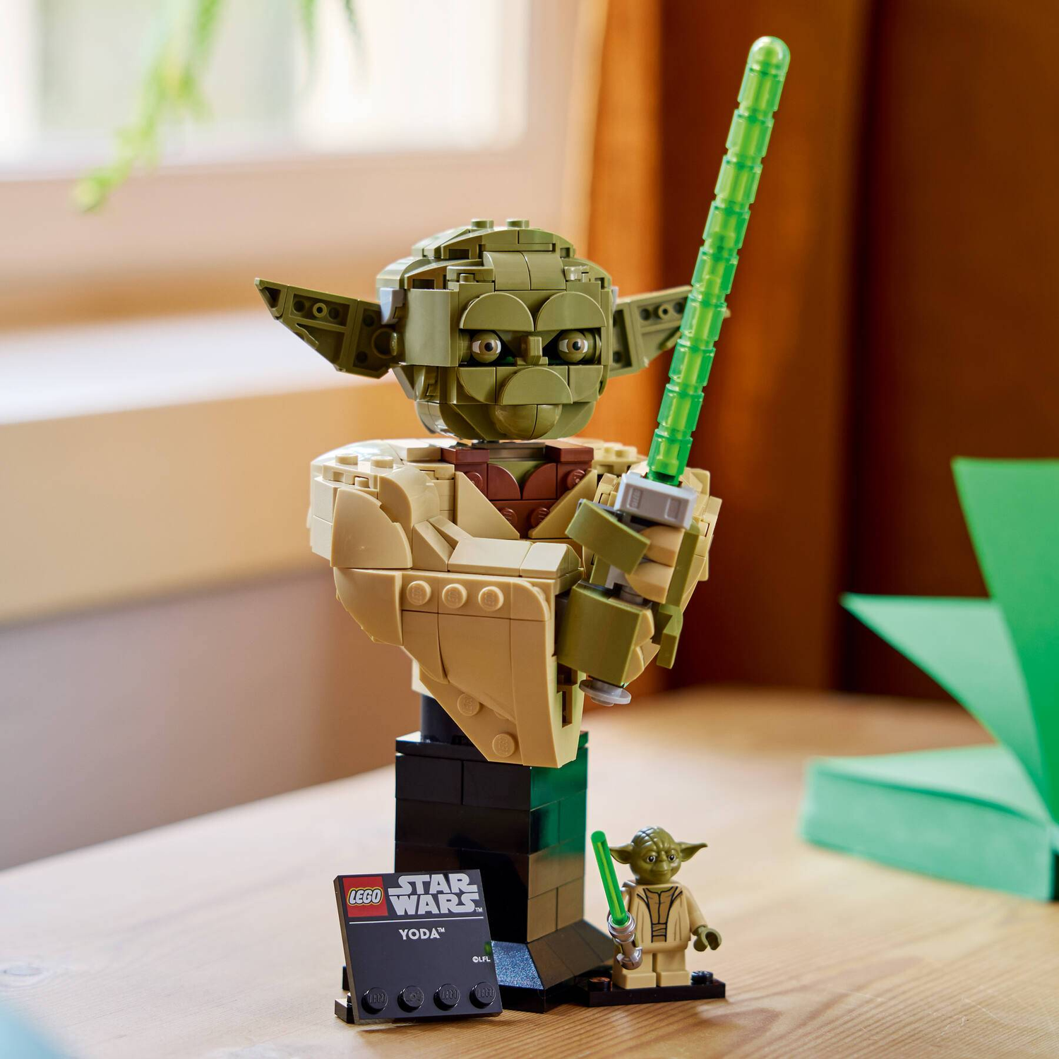 LEGO Star Wars bust of Yoda with a lightsaber and minifigure.