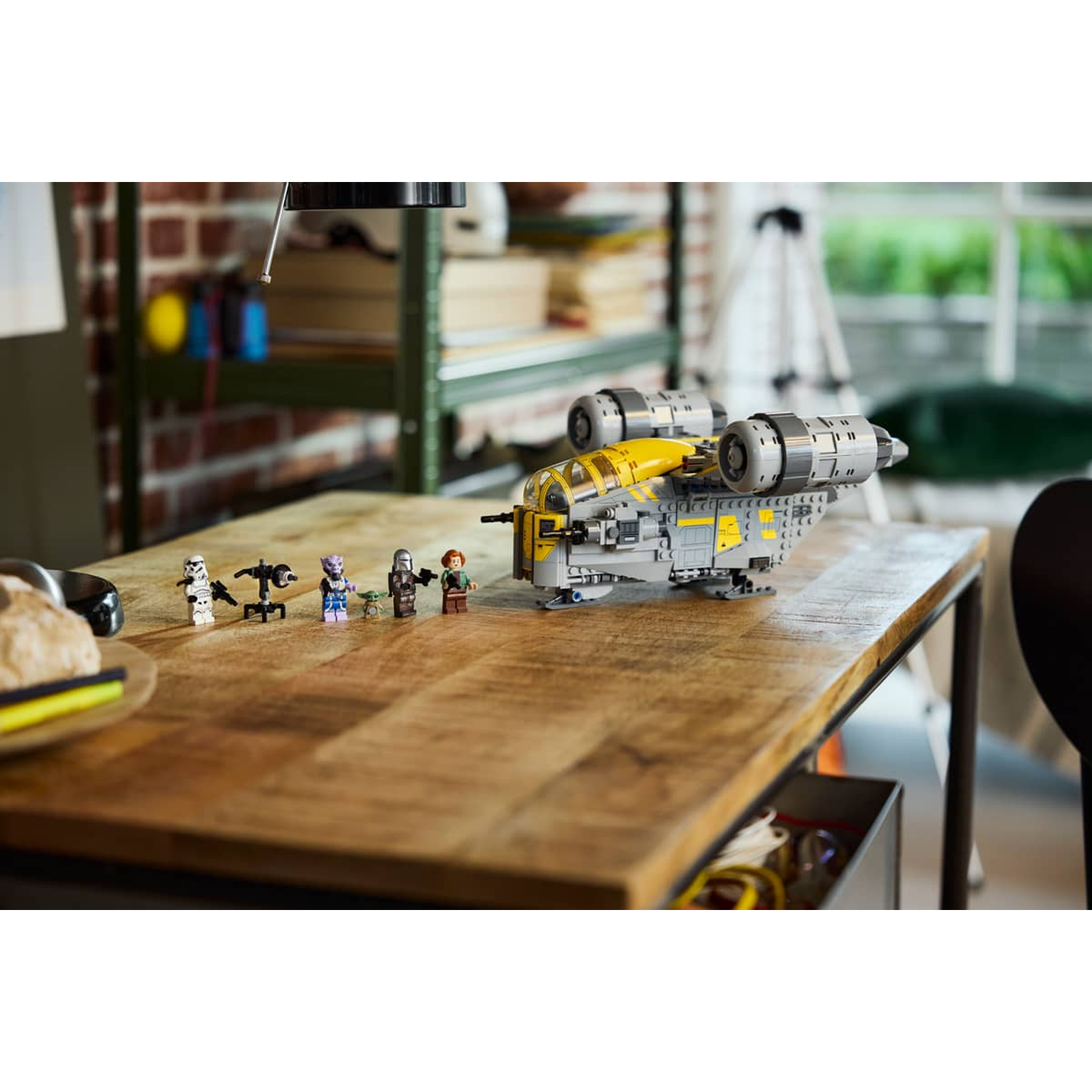 Lego starship with figures on a wooden table. Includes The Mandalorian figures.