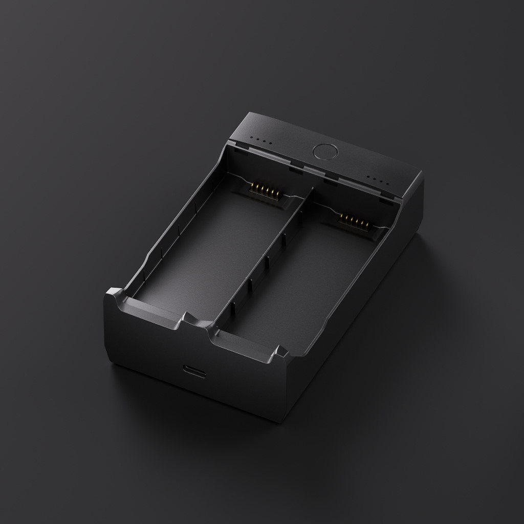 Chargeur double noir avec contacts de charge et port USB-C.
