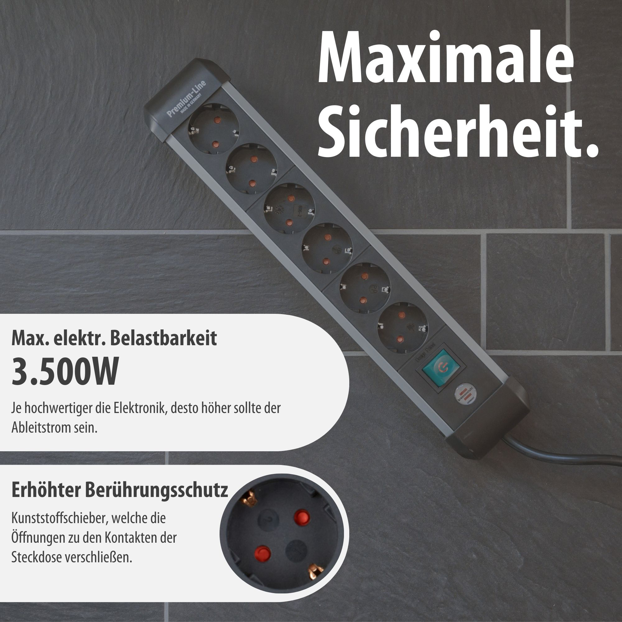Eine graue Steckdosenleiste mit mehreren Steckplätzen und einem Ein-/Ausschalter auf dunklem Untergrund.
