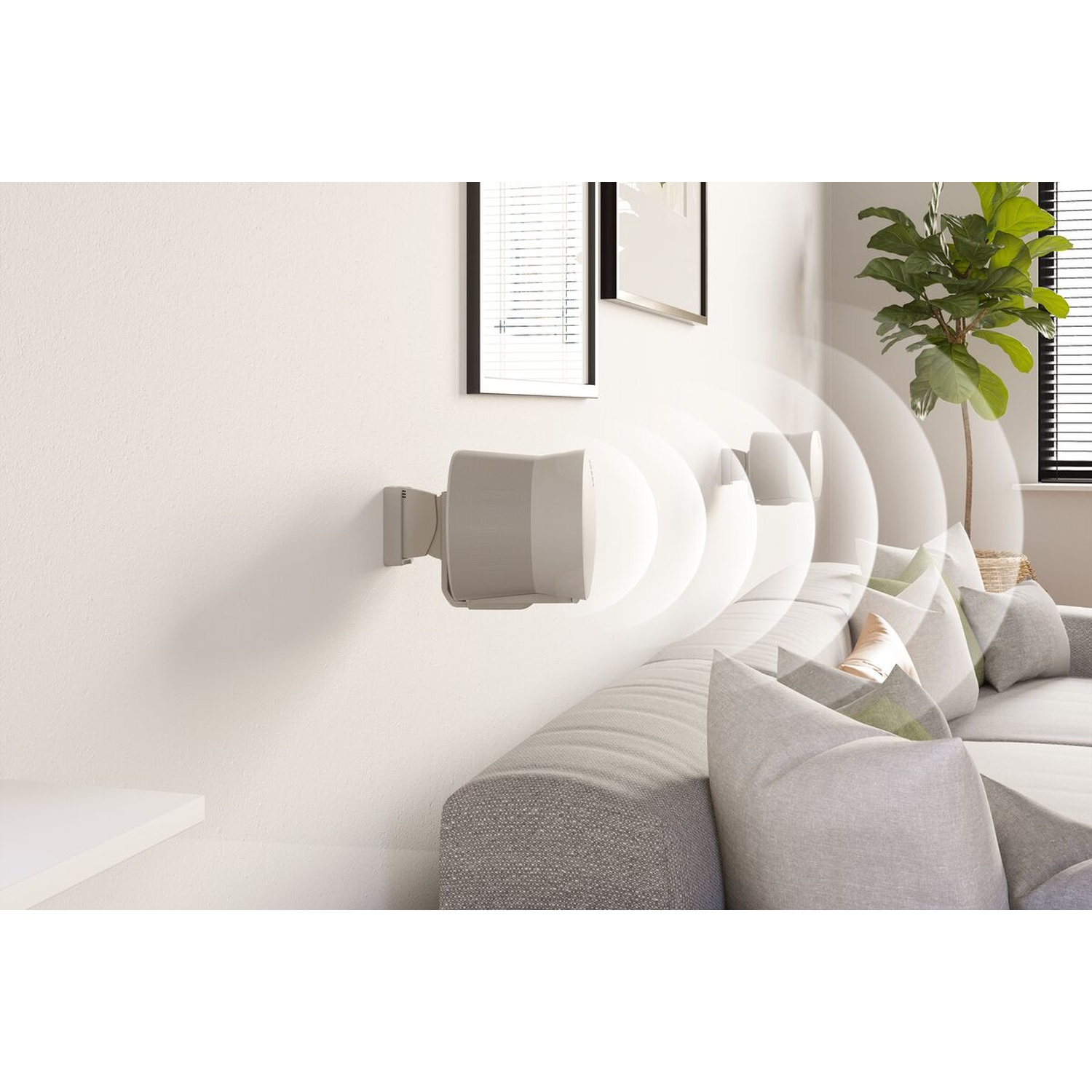 Wall-mounted speakers emit sound waves in a modern living room with a sofa.