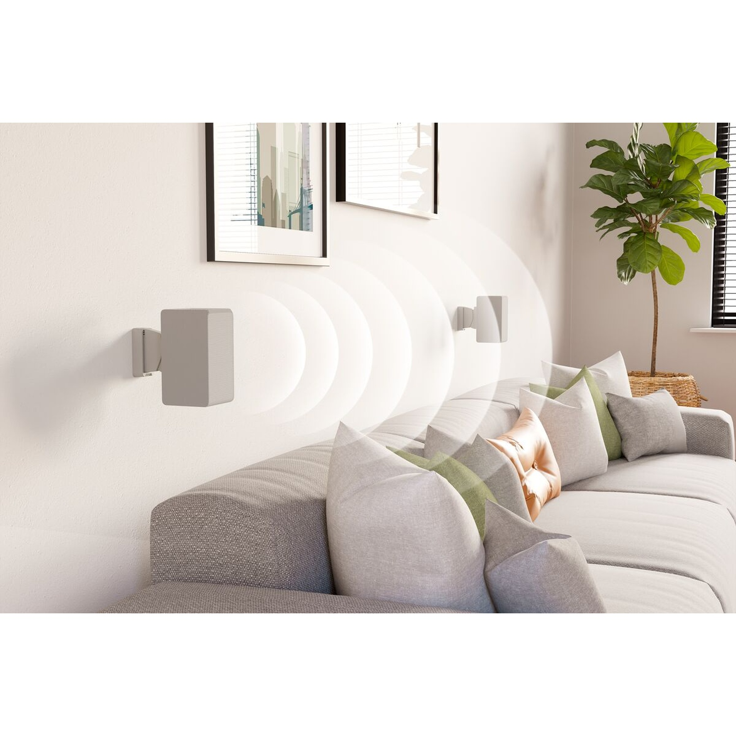 Gray speakers on the wall above a sofa with cushions, next to a plant.