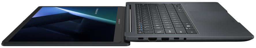 Egy sötét laptop nyitott képernyővel, kék geometrikus mintát mutatva.