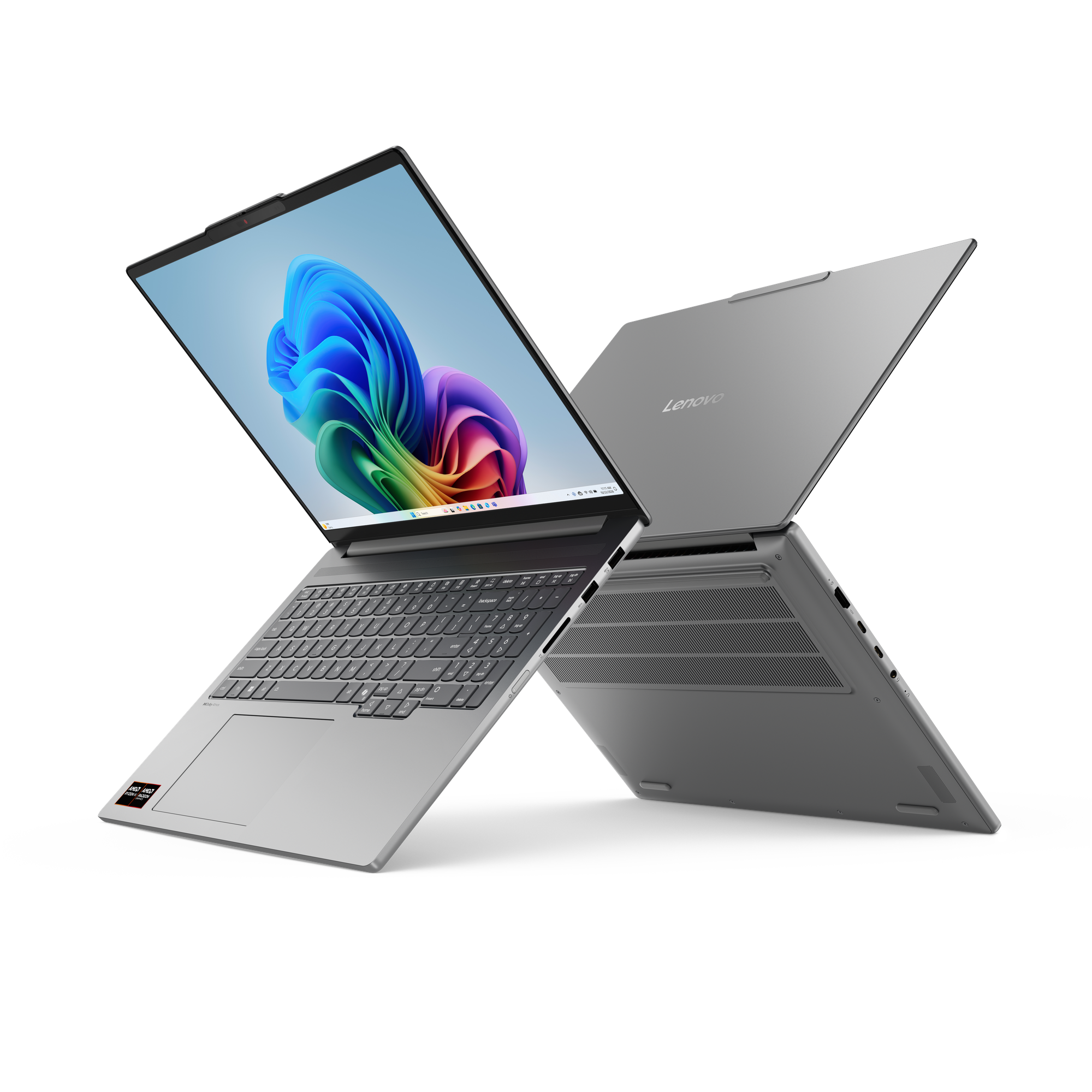 Zwei silberne Laptops auf schwarzem Hintergrund, einer geöffnet mit bunter Anzeige.
