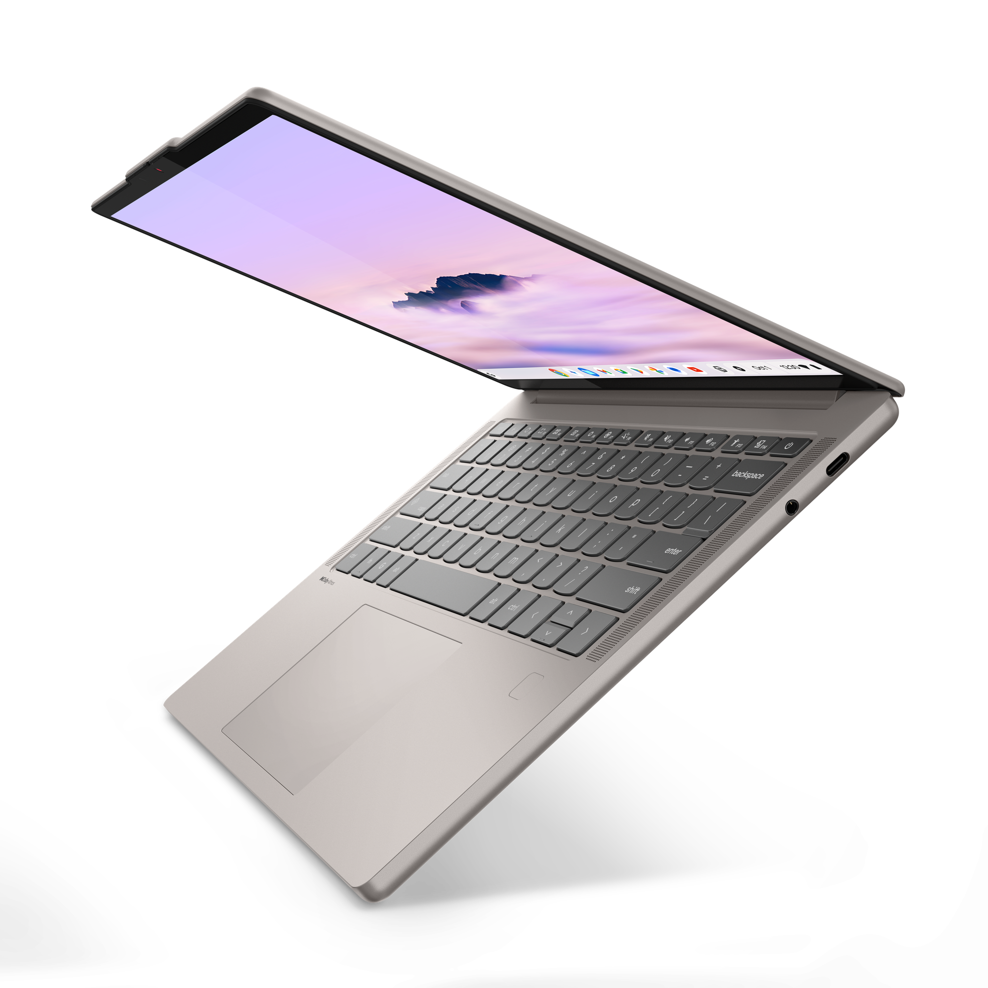 Ein offener silberner Laptop mit einer Tastatur und einem Bildschirm, der einen violetten Himmel zeigt.