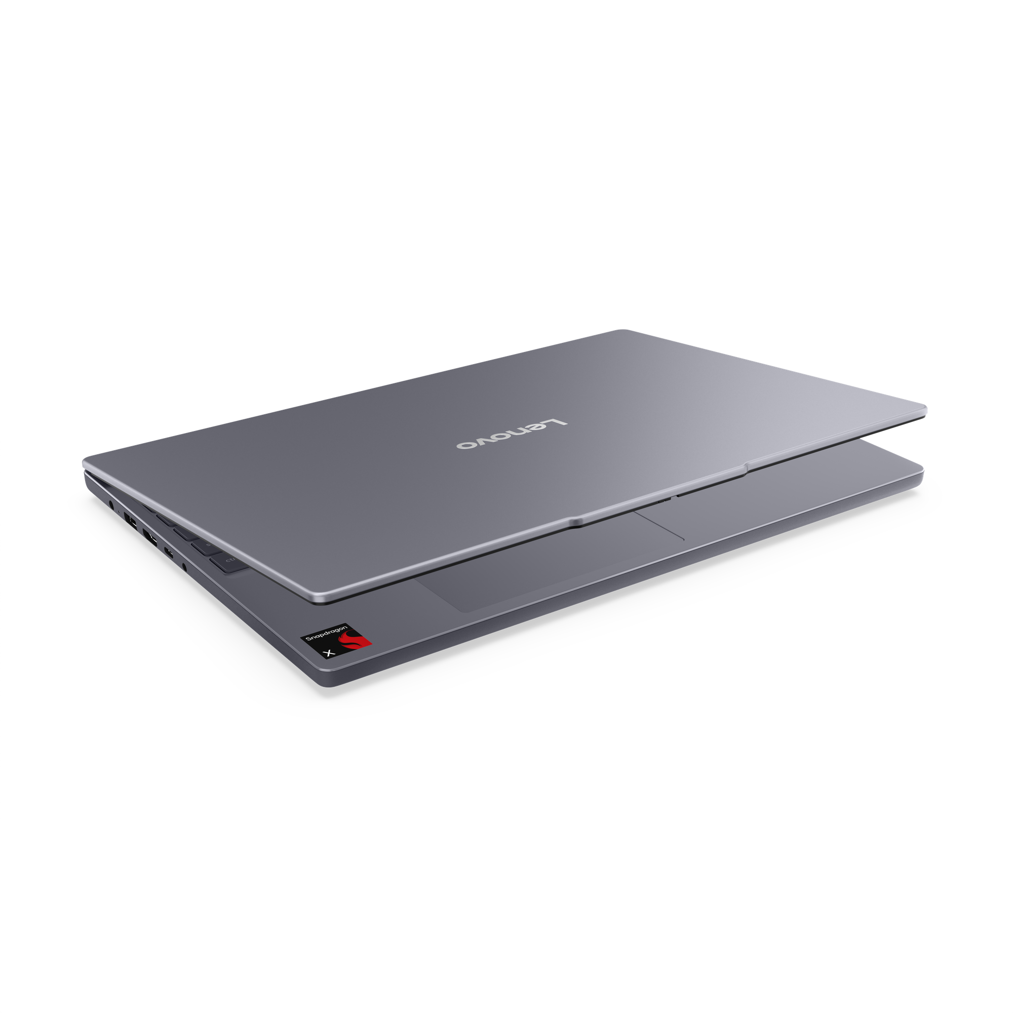 Grauer Lenovo Laptop mit Snapdragon X-Aufkleber, schwarzer Hintergrund.