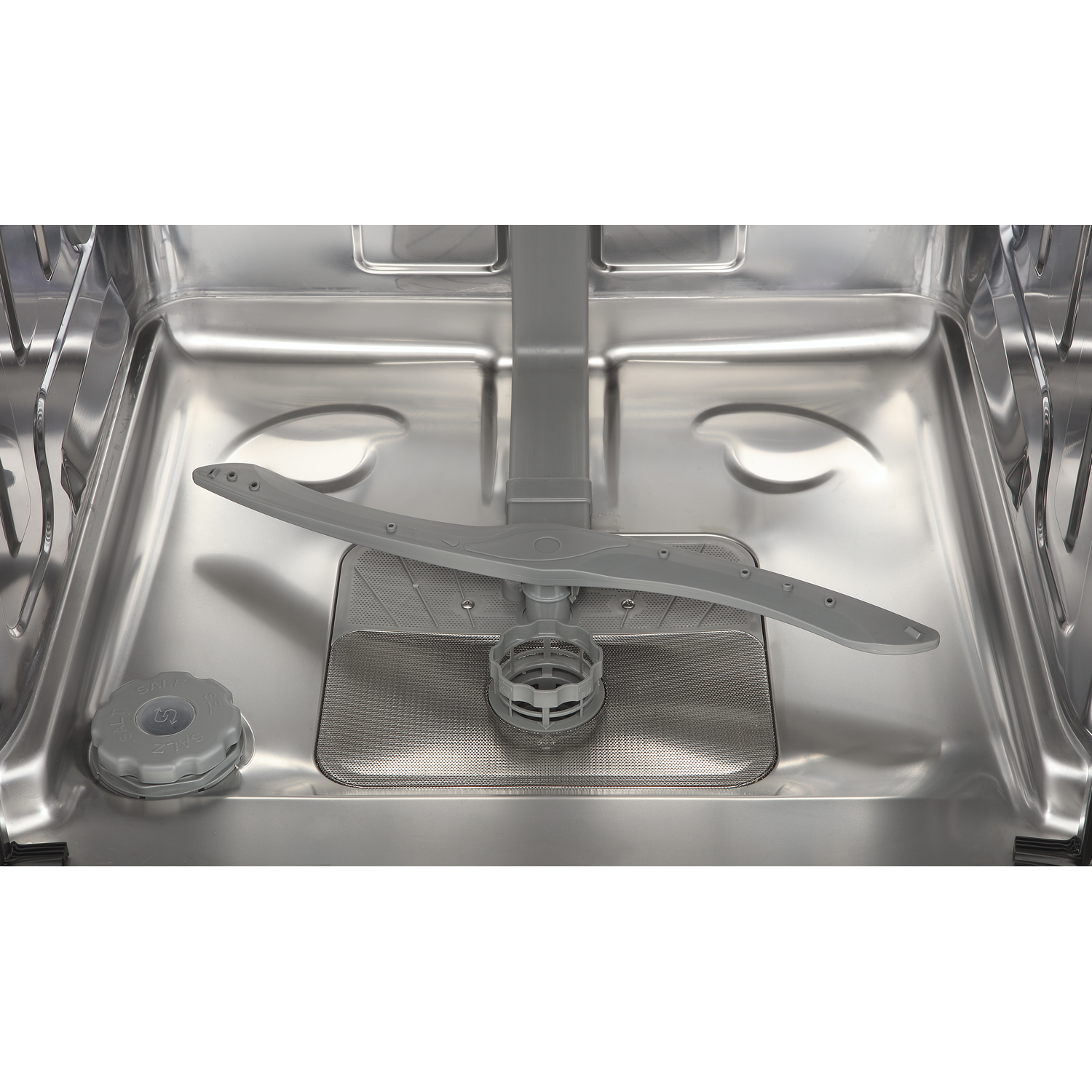 Interior of a dishwasher with spray arm and salt container.