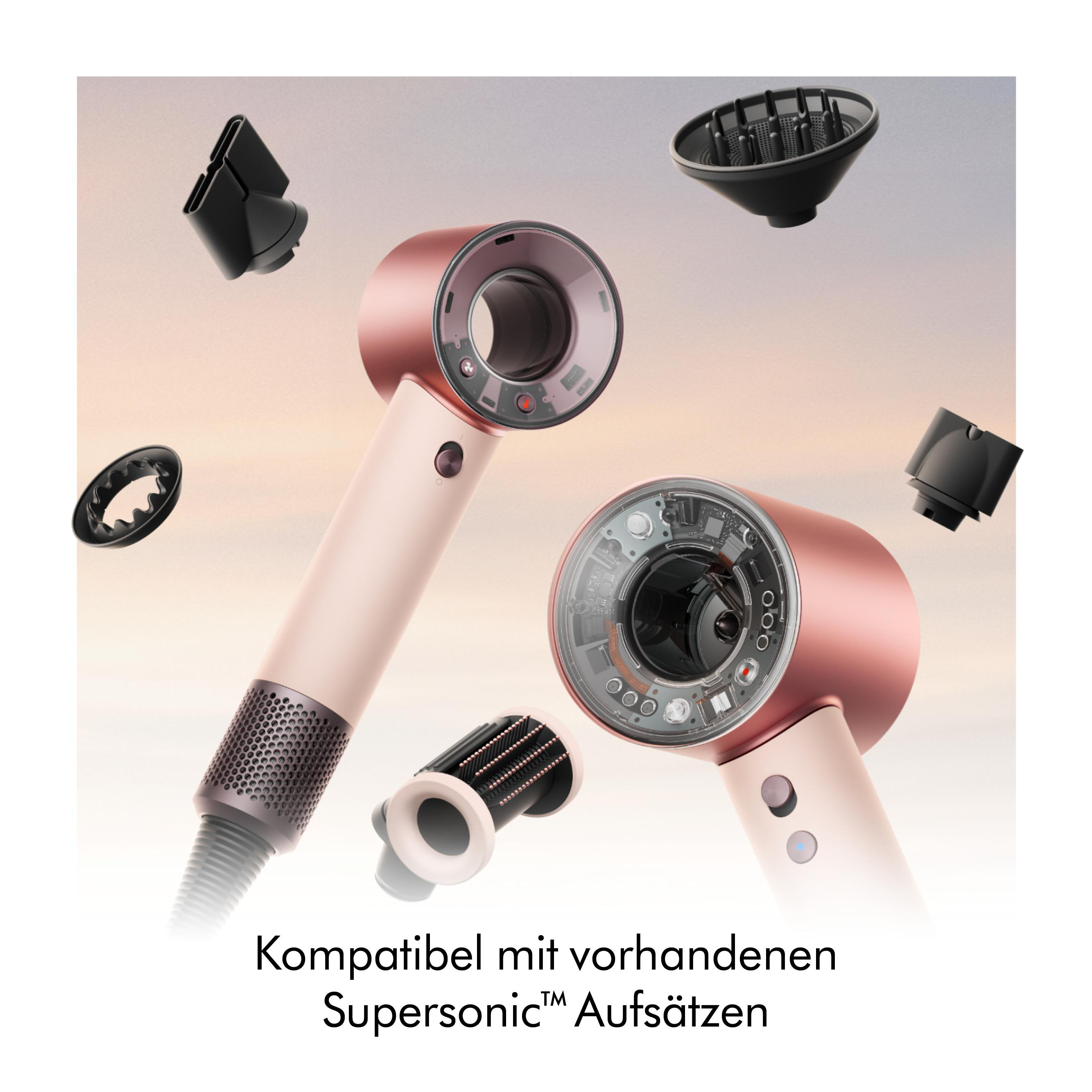 Rosegold Haartrockner mit Zubehörteilen vor hellem Hintergrund.