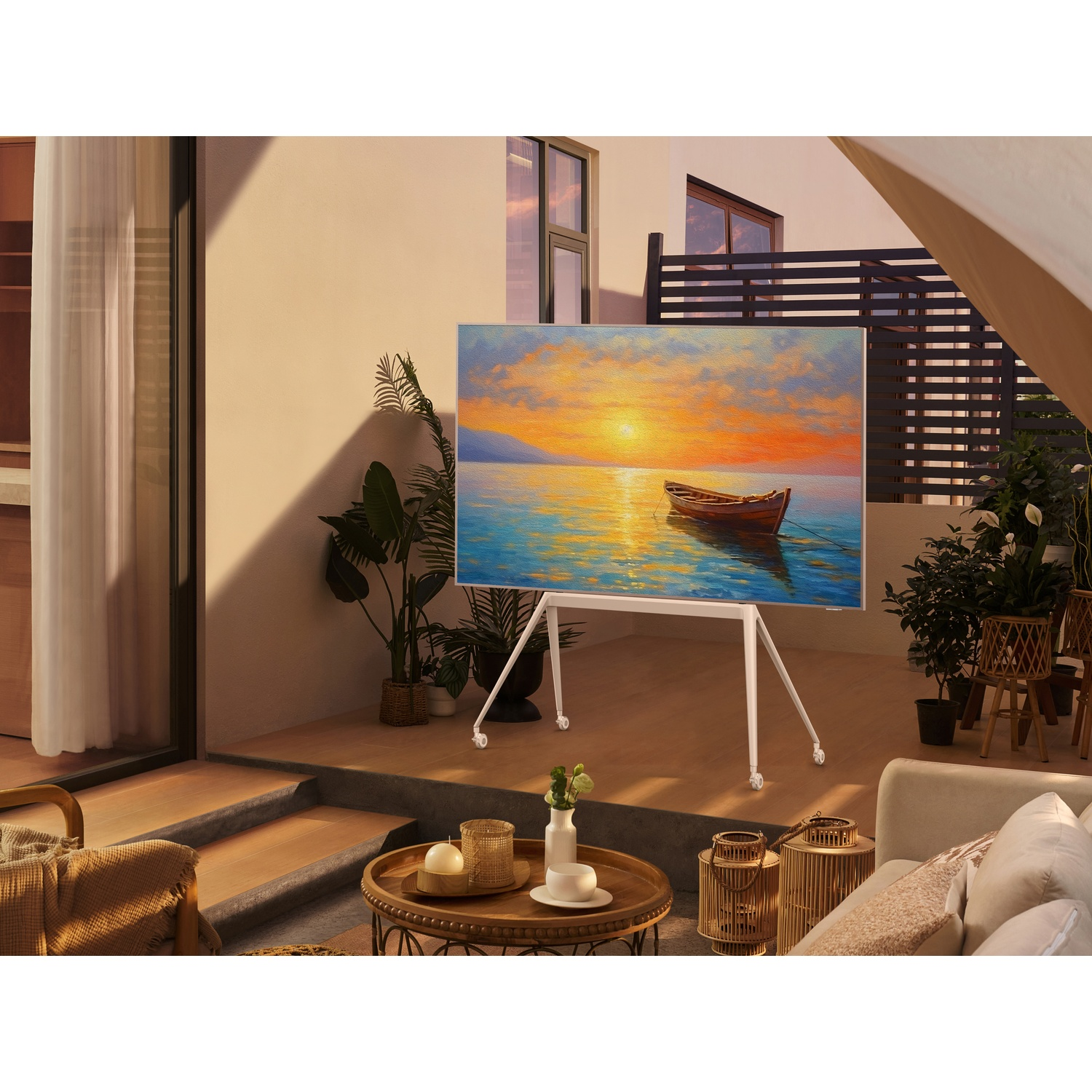 A TV displays a painting of a boat at sunset, on a stand outdoors.