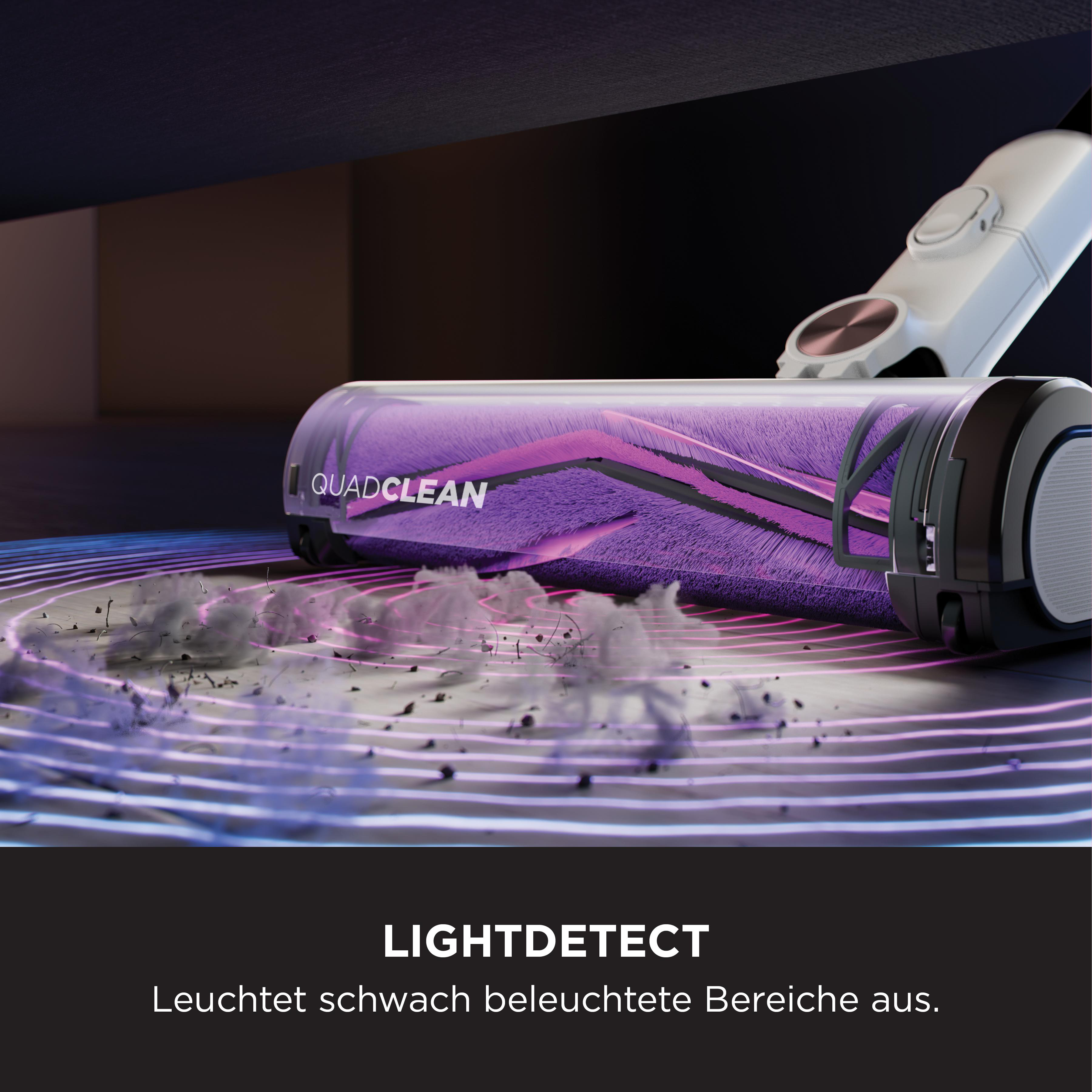 Staubsaugerbürste reinigt Boden mit violettem Licht und wirbelt Staub auf.