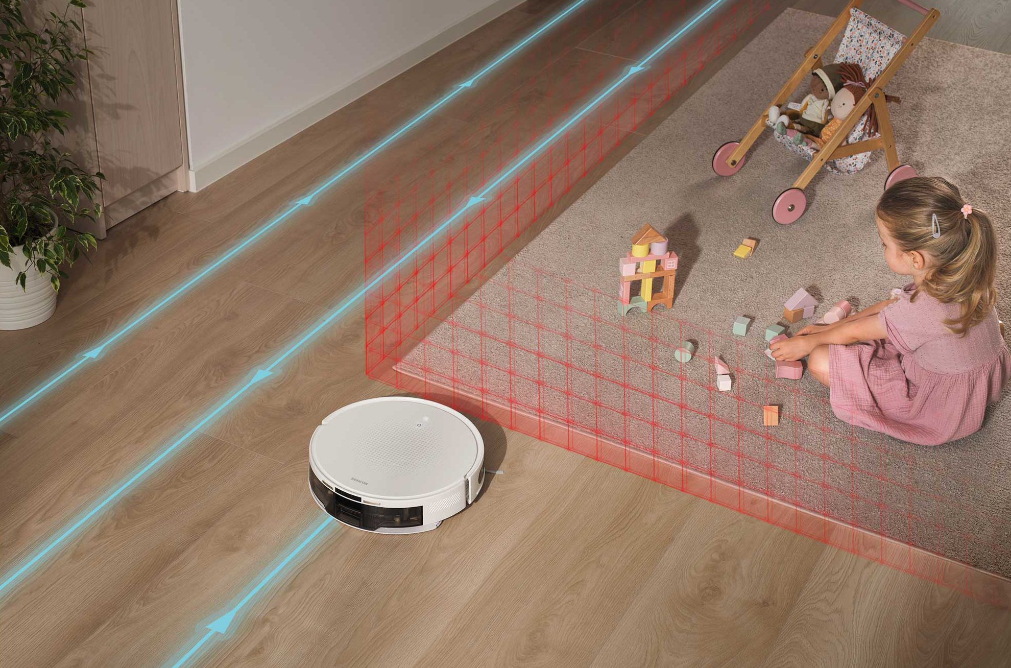 Egy robotporszívó tisztít egy fapadlót, egy gyerek építőkockákkal játszik egy szőnyegen.