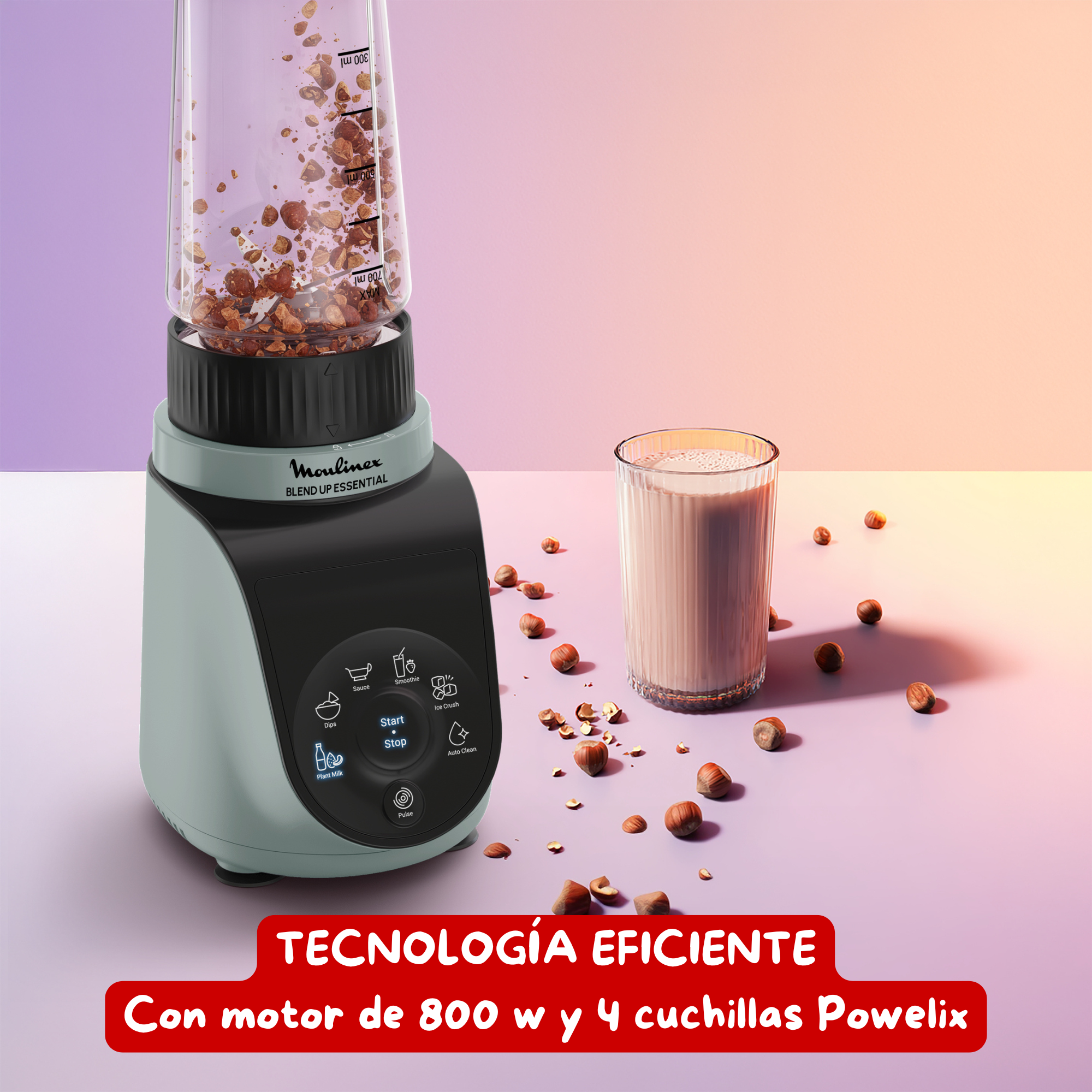 Una licuadora con un vaso, nueces y una bebida. La licuadora es verde claro y negra.
