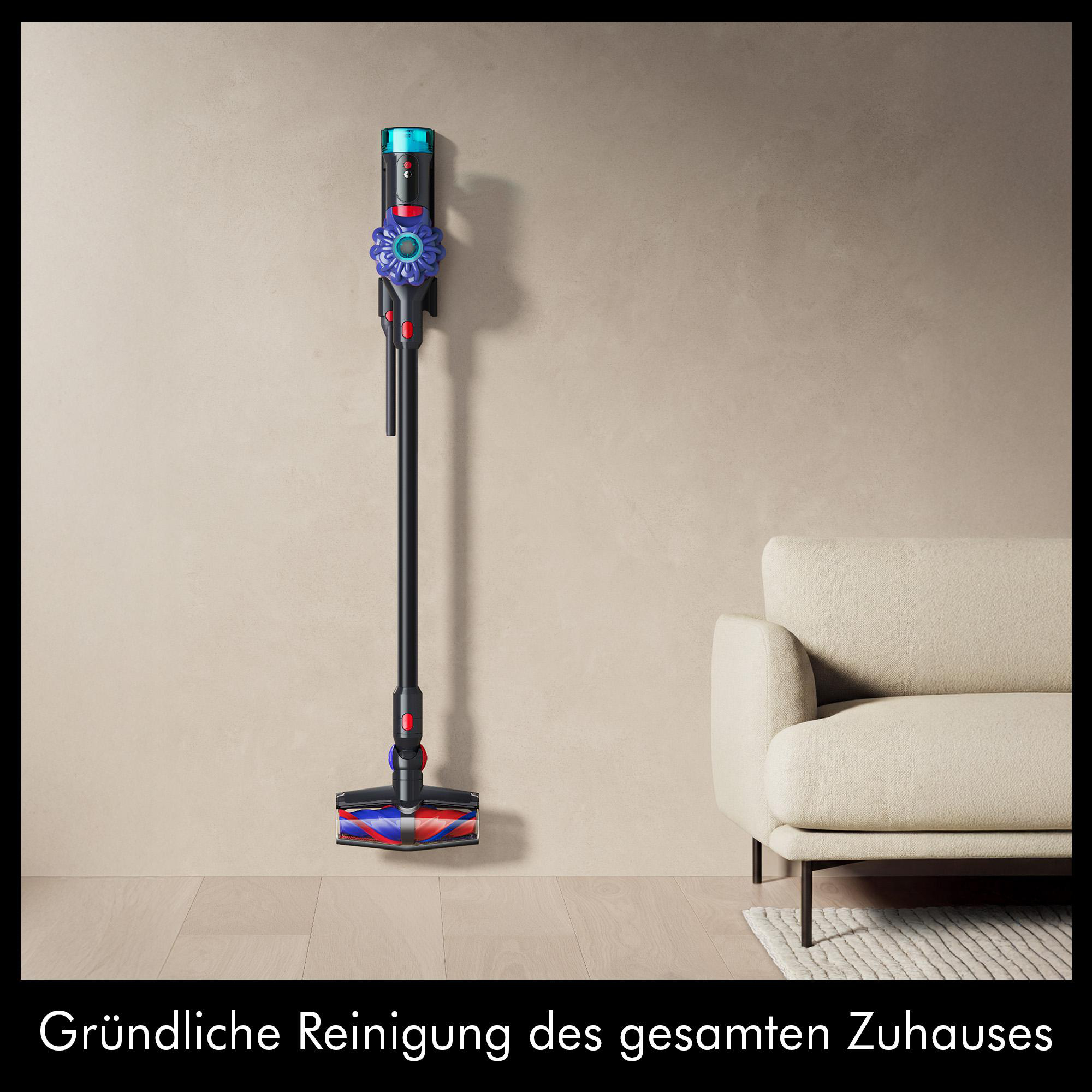 Ein kabelloser Staubsauger steht neben einem beigen Sofa auf einem Holzboden.