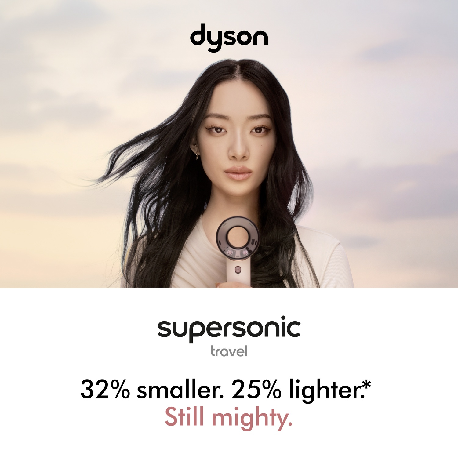 Woman holding Dyson Supersonic hair dryer, 32% smaller, 25% lighter.