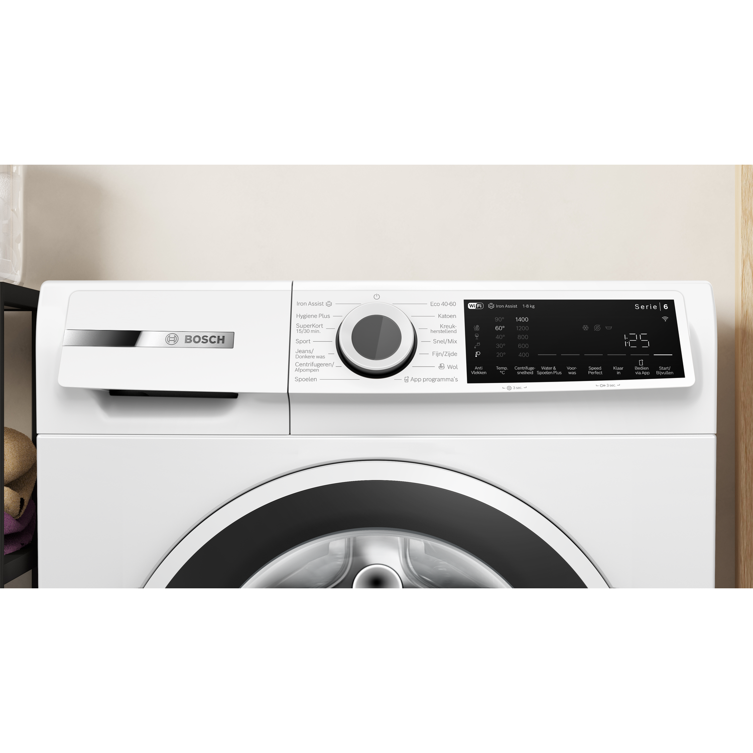 White Bosch washing machine with control panel and drum. Electronic display.