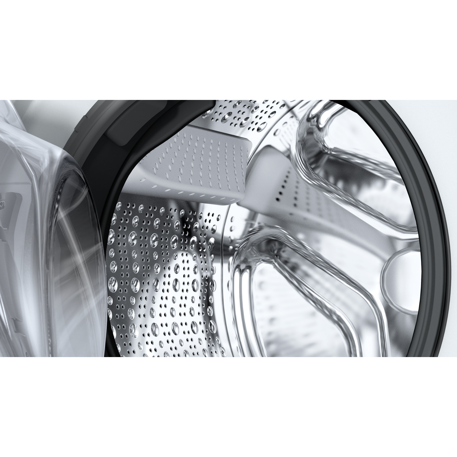 Close up of a washing machine drum with water droplets on the stainless steel surface.