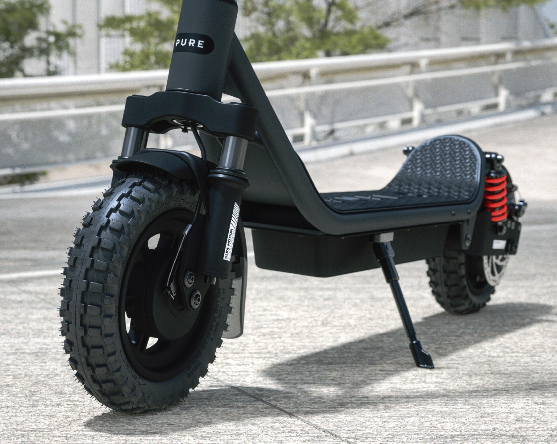 Schwarzer E-Scooter mit groben Reifen und roten Stoßdämpfern auf Beton.