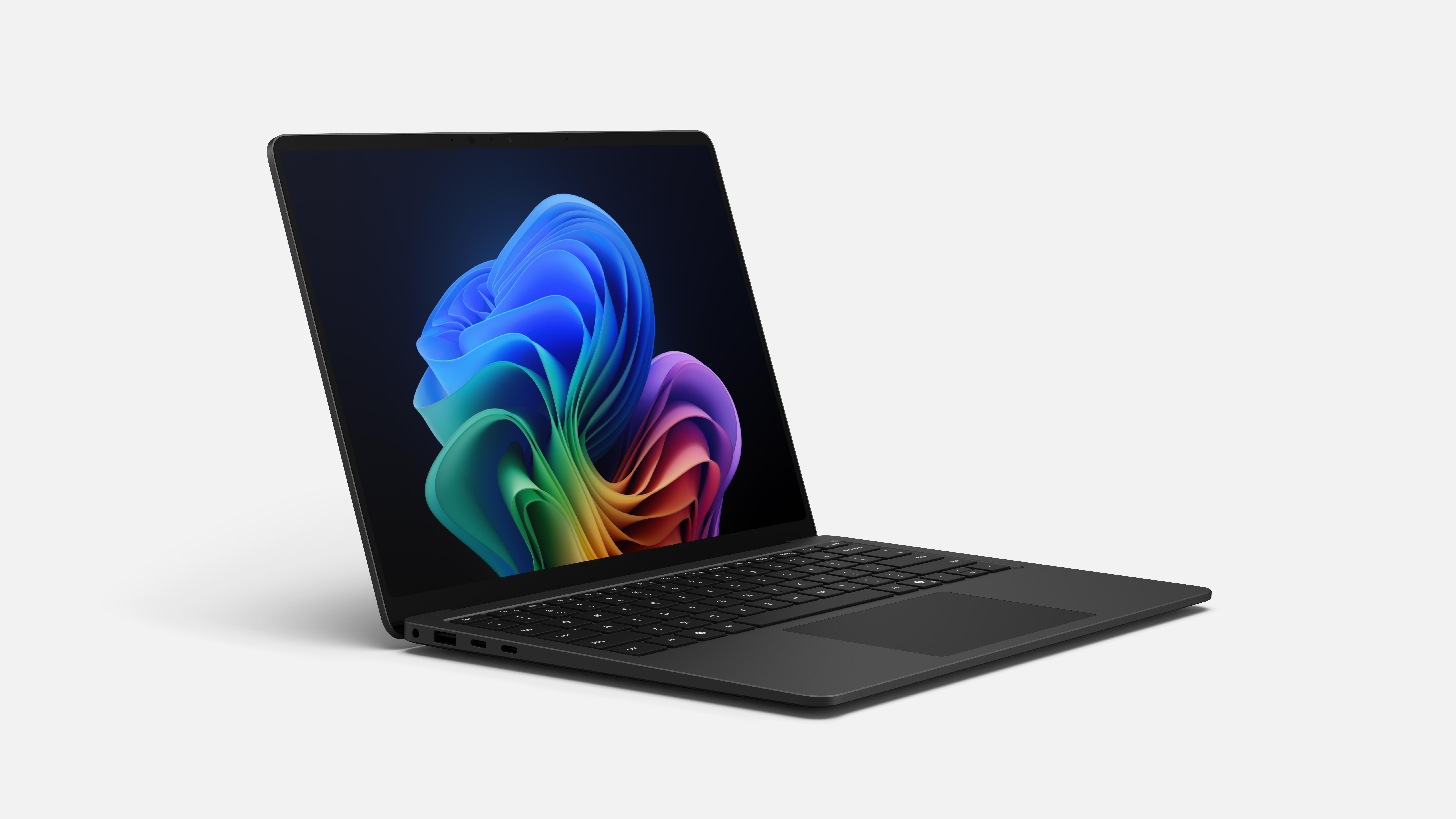 Schwarzer Laptop mit farbenfrohem Hintergrundbild auf dem Bildschirm.