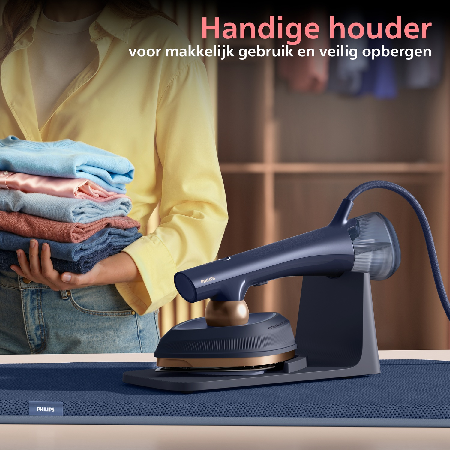 A garment steamer rests on its stand next to a stack of folded clothes.