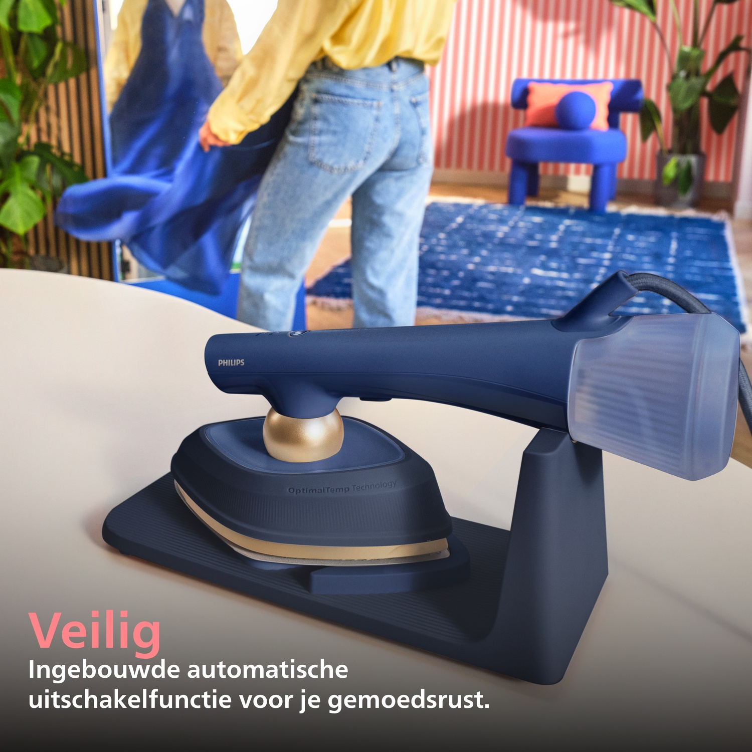 Steam iron on stand, person with blue dress reflected in mirror.
