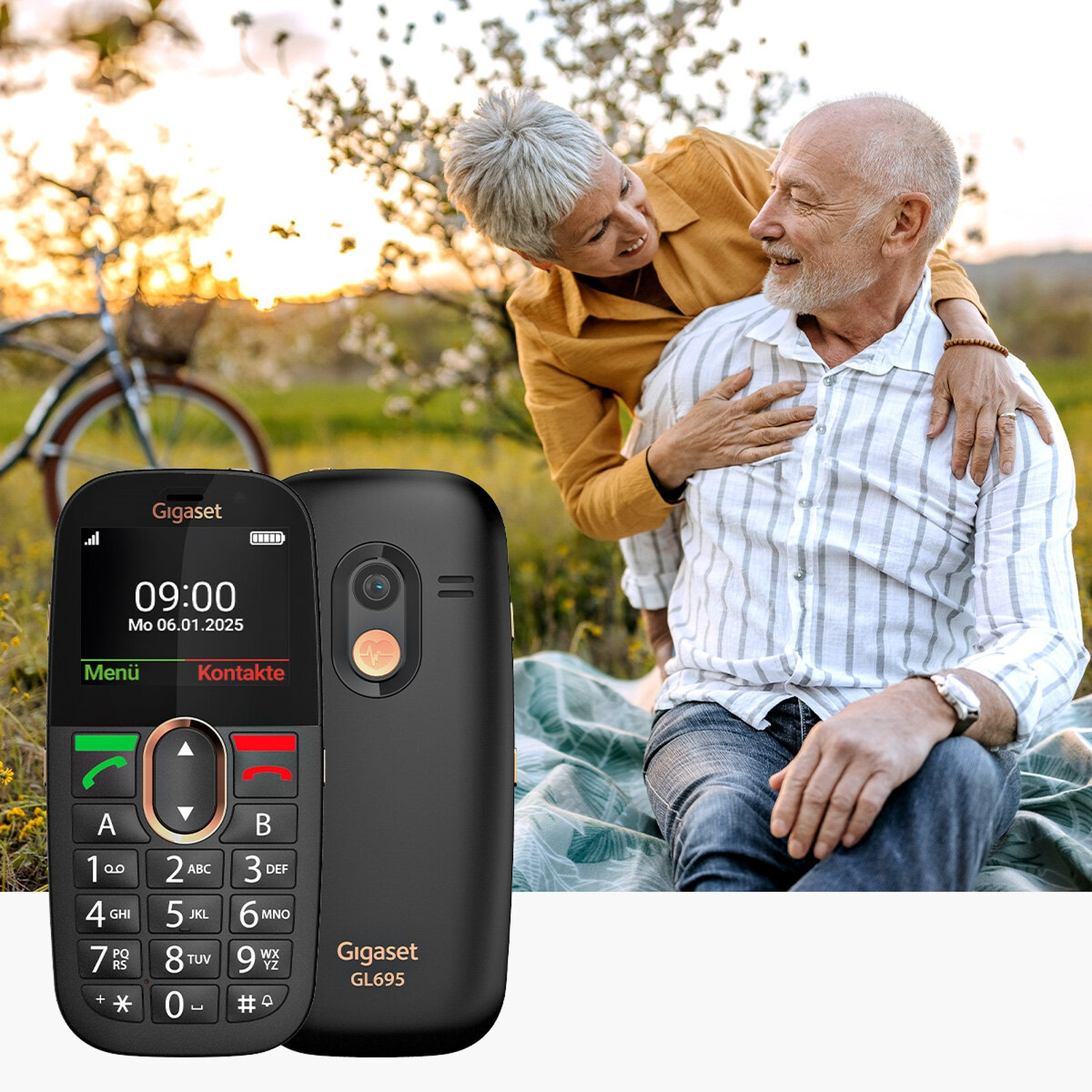 Elderly couple outdoors with a Gigaset phone in the foreground.