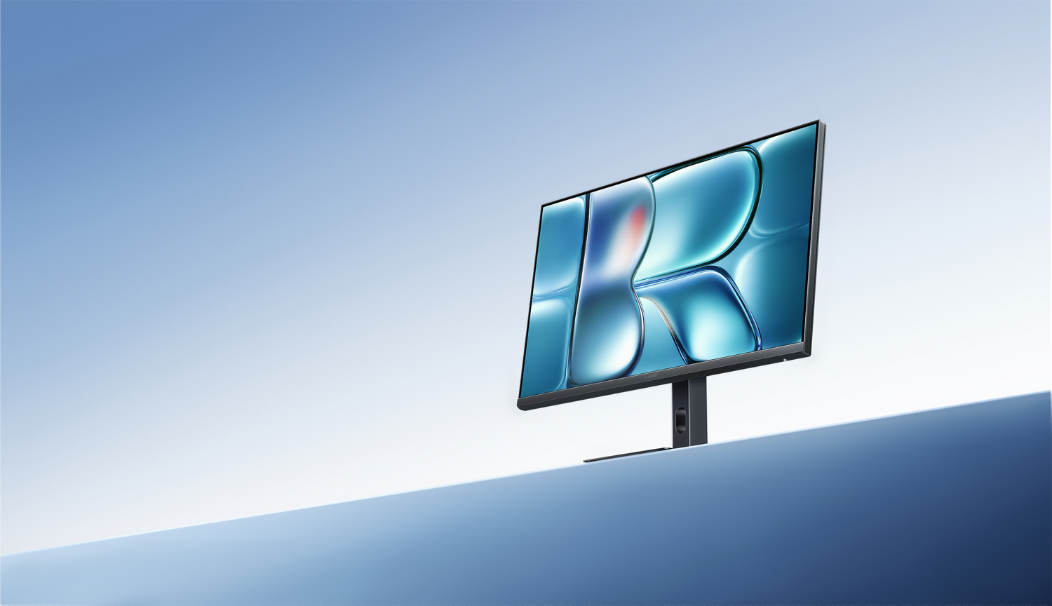 Un elegante monitor de computadora muestra un gráfico abstracto azul contra un cielo despejado.