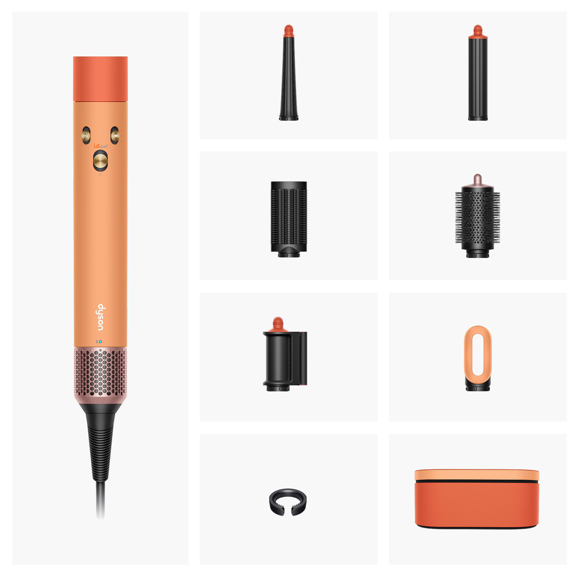 Ein korallenfarbener Dyson-Haarstyler mit Aufsätzen und Aufbewahrungsbox.