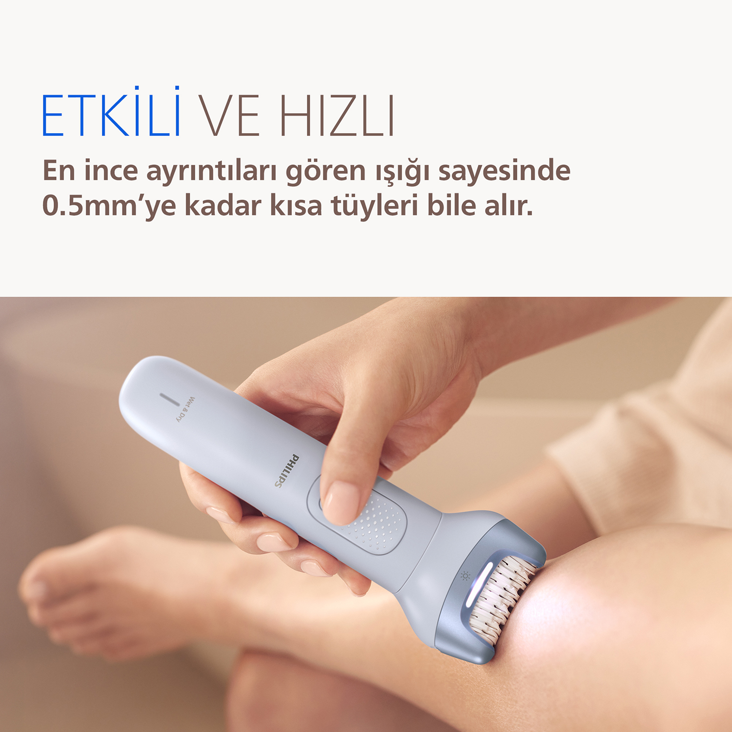 Bir el, bacakta kullanılan bir Philips epilatör tutuyor.