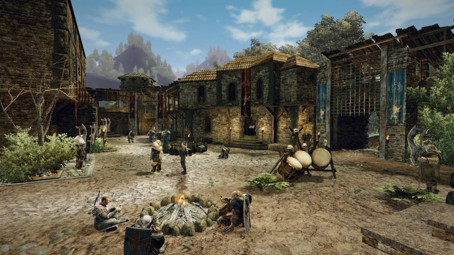 Un pueblo medieval con edificios de piedra, figuras y una hoguera.