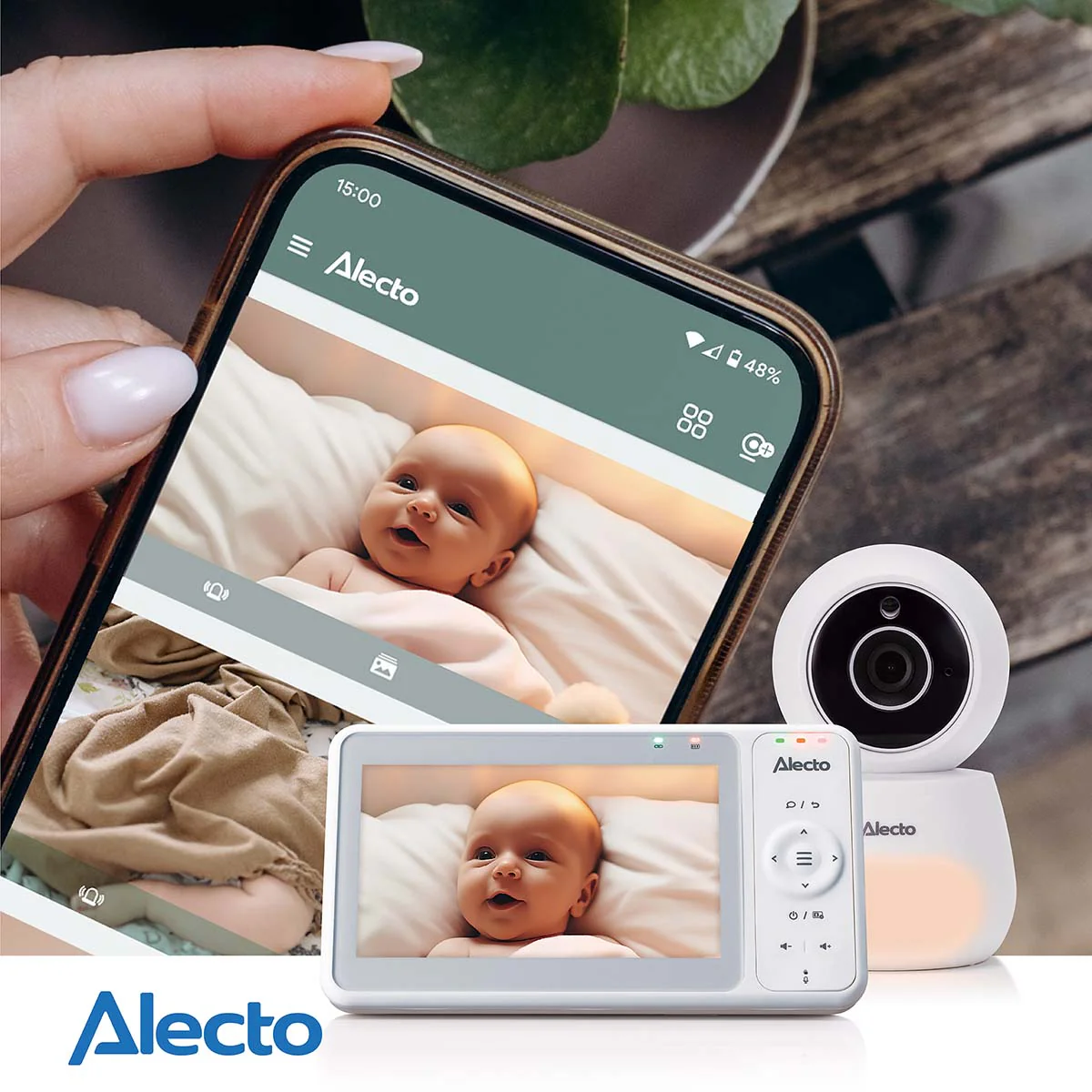 Un babyphone avec caméra et écran. Un bébé est allongé sur un lit.