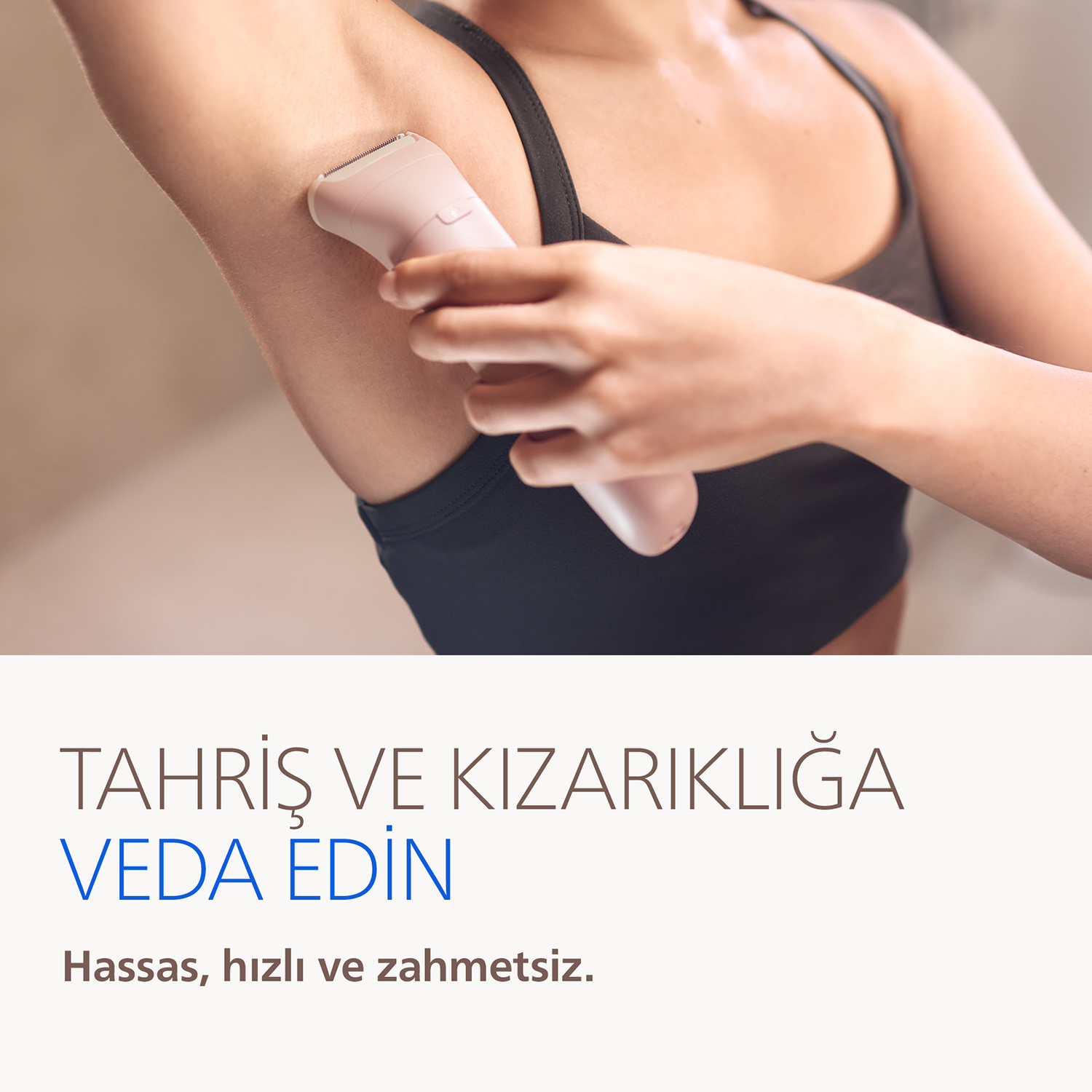 Kadın pembe epilatörle koltuk altını tıraş ediyor. Pürüzsüz cilt.