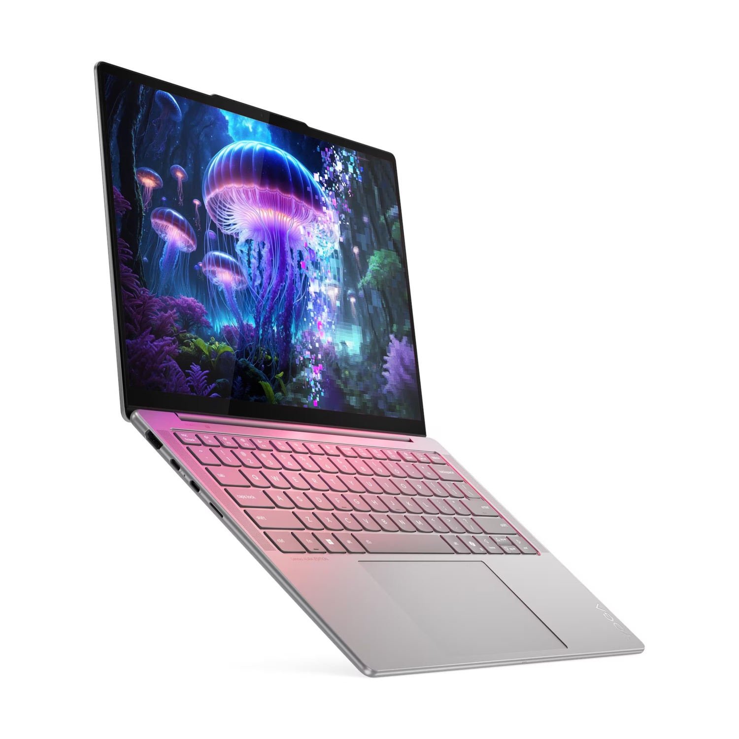 Un laptop argento con tastiera rosa mostra una medusa luminosa su sfondo scuro.
