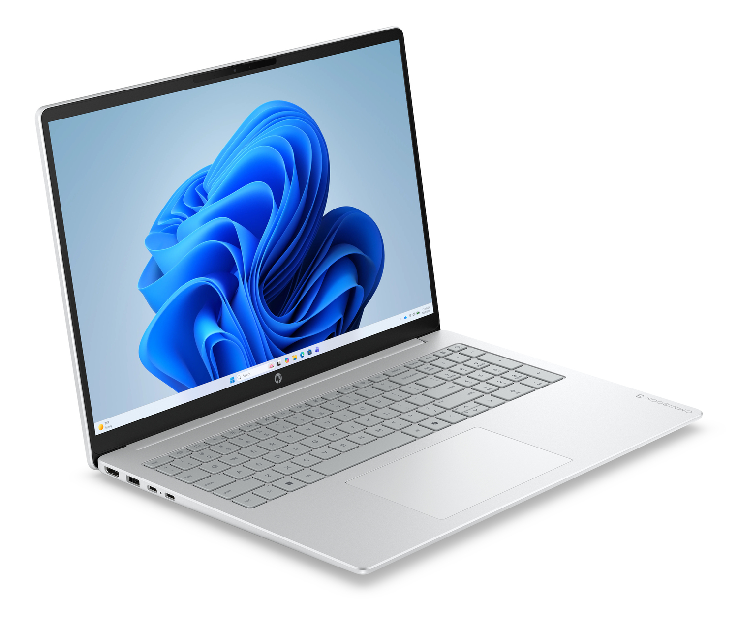 Un portátil plateado con la pantalla iluminada, mostrando el logo de Windows 11.