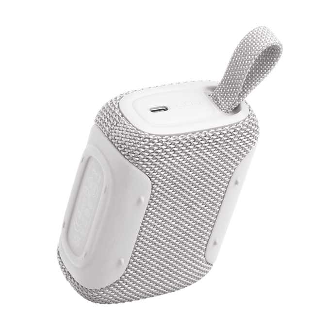 Un altavoz portátil blanco con rejilla de tela y correa.