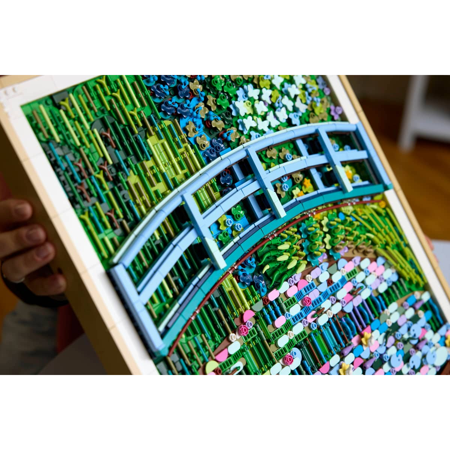 A Lego recreation of Monet's garden, featuring a blue bridge and colorful flowers.