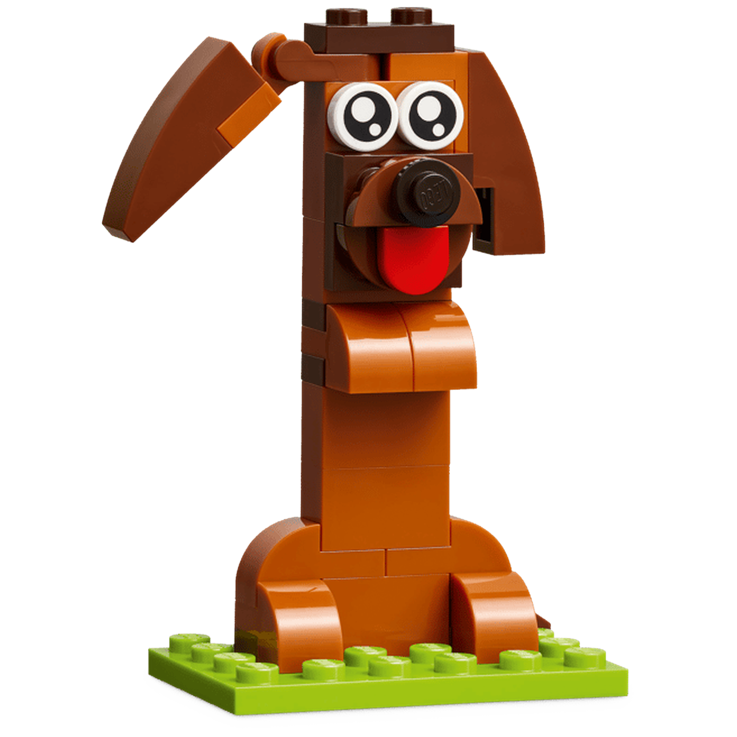 Een bruine Lego-hond met slappe oren en een rode tong staat op een groene ondergrond.