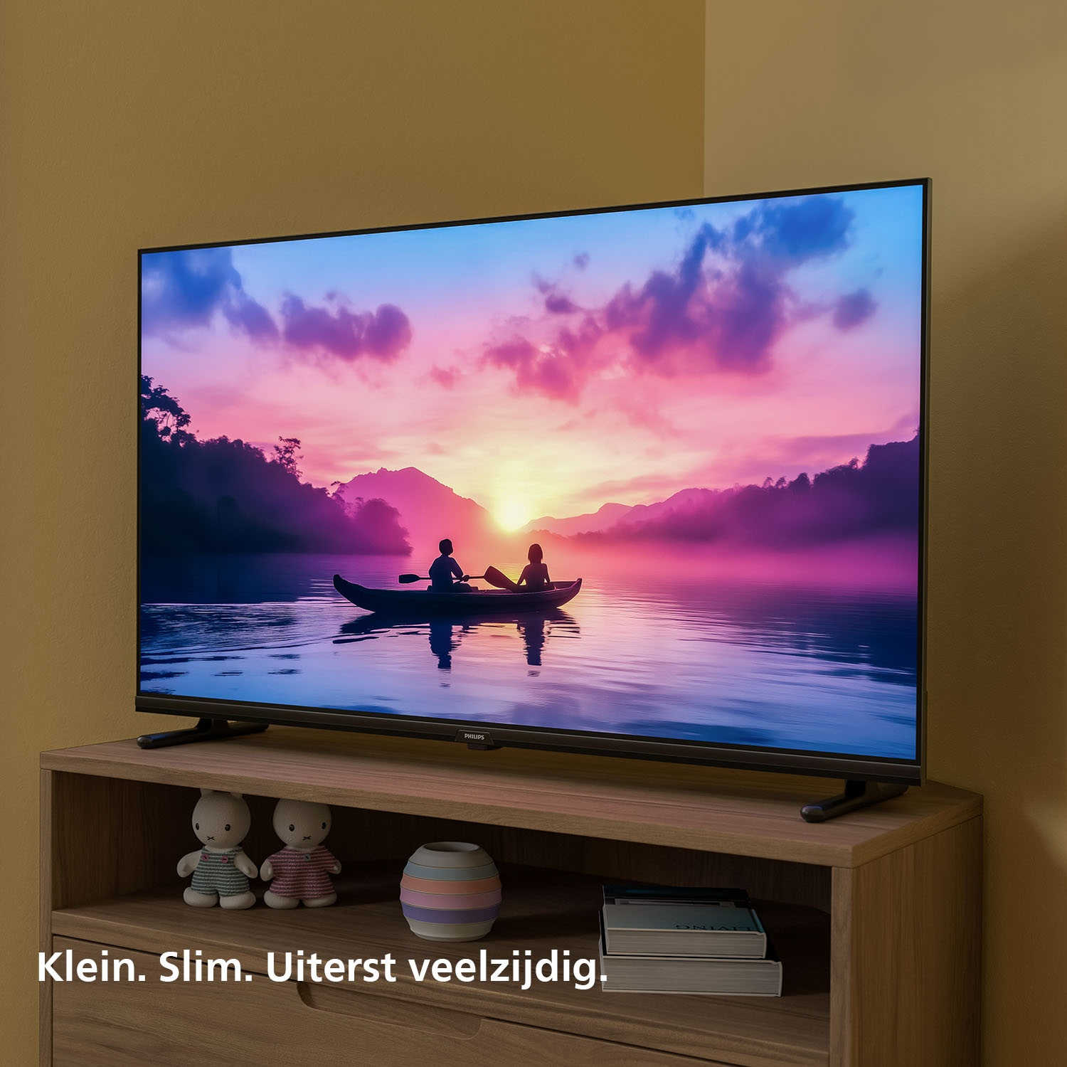 A TV displays a sunset scene with two people in a kayak on water.