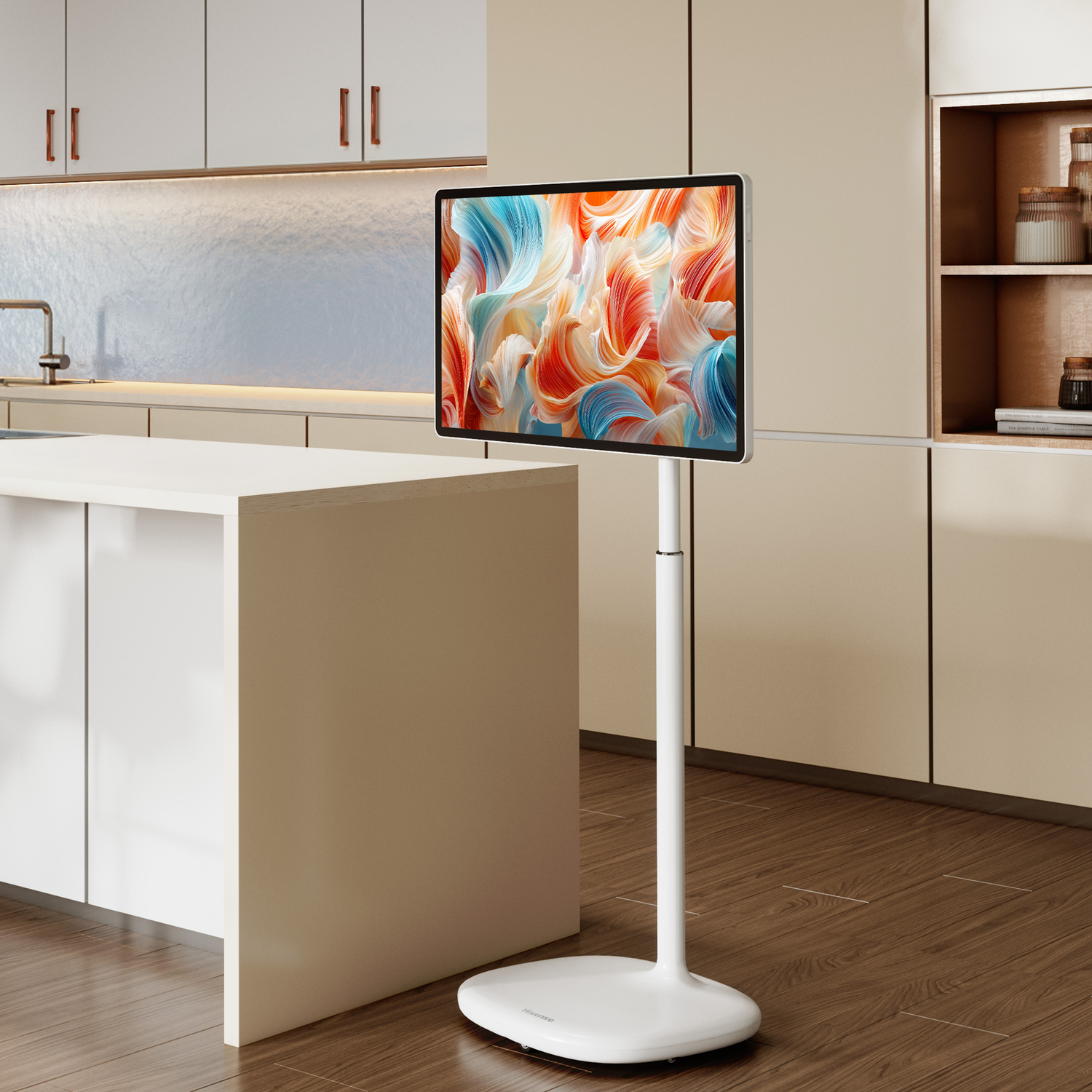 A modern white TV on a stand in a bright kitchen setting.