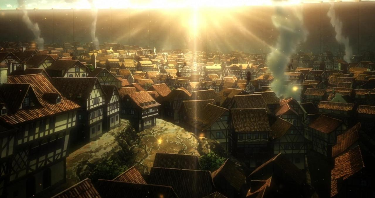 Eine Stadt mit Fachwerkhäusern unter einer riesigen Mauer bei Sonnenaufgang.