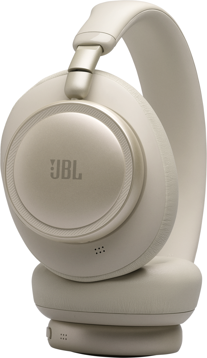 Eine nahaufnahme von einem beigen JBL-Kopfhörer vor schwarzem Hintergrund.