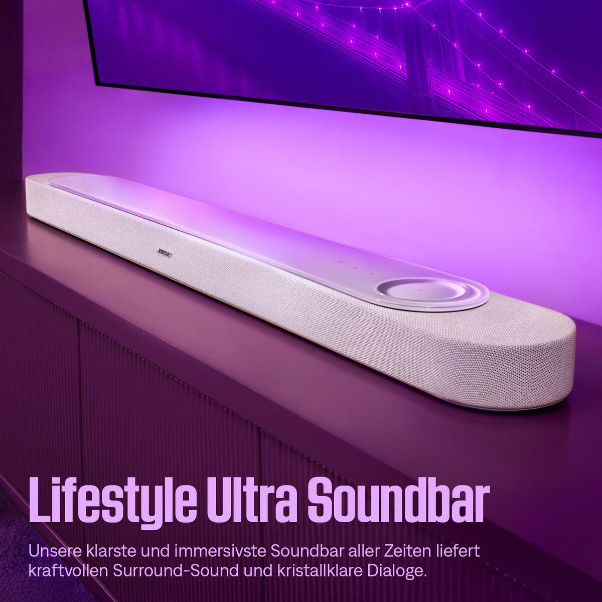 Weiße Bose Soundbar auf lila Kommode, beleuchtet von lila Licht.