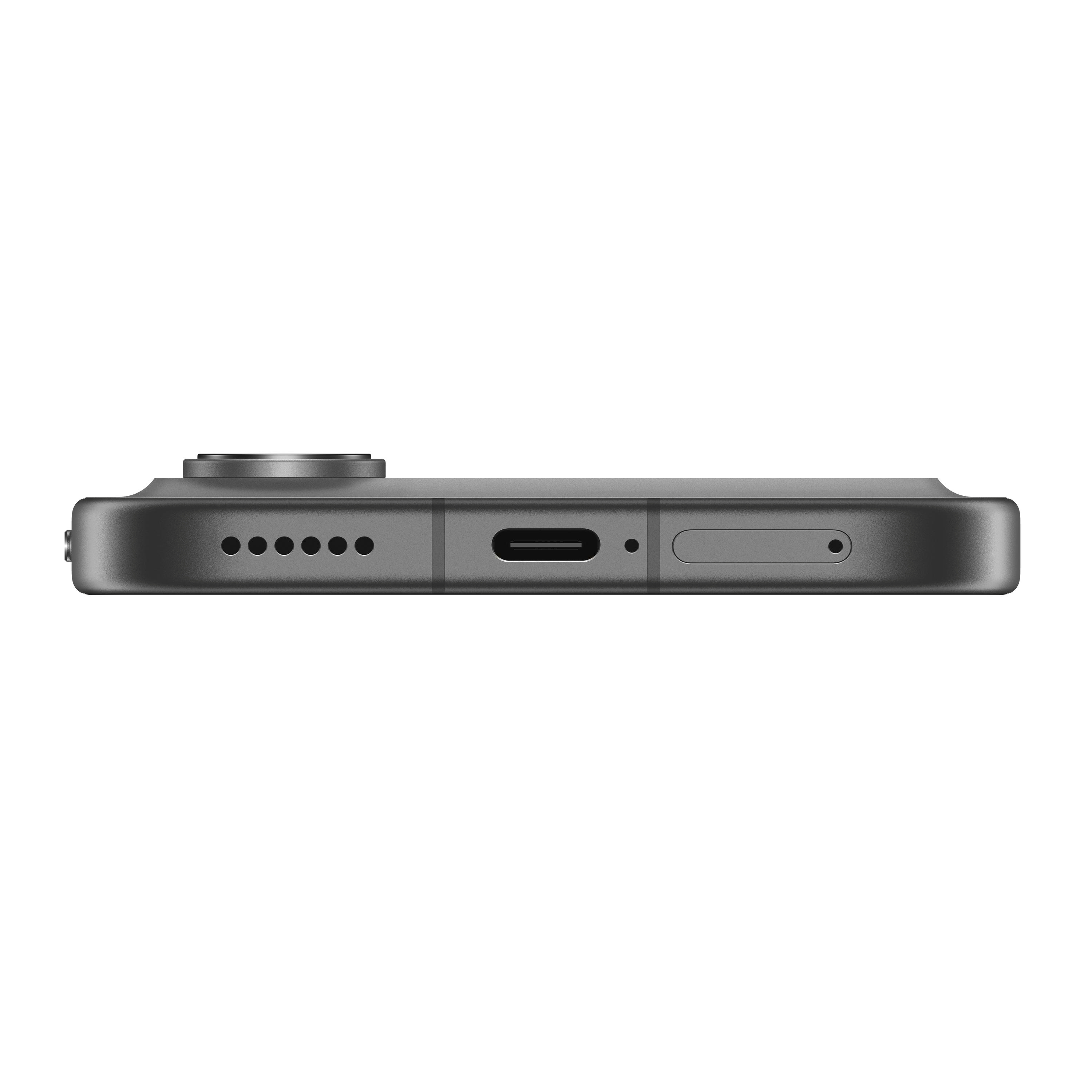 Die Unterseite eines grauen Smartphones mit Ladeanschluss, Lautsprechergrill und SIM-Schublade.