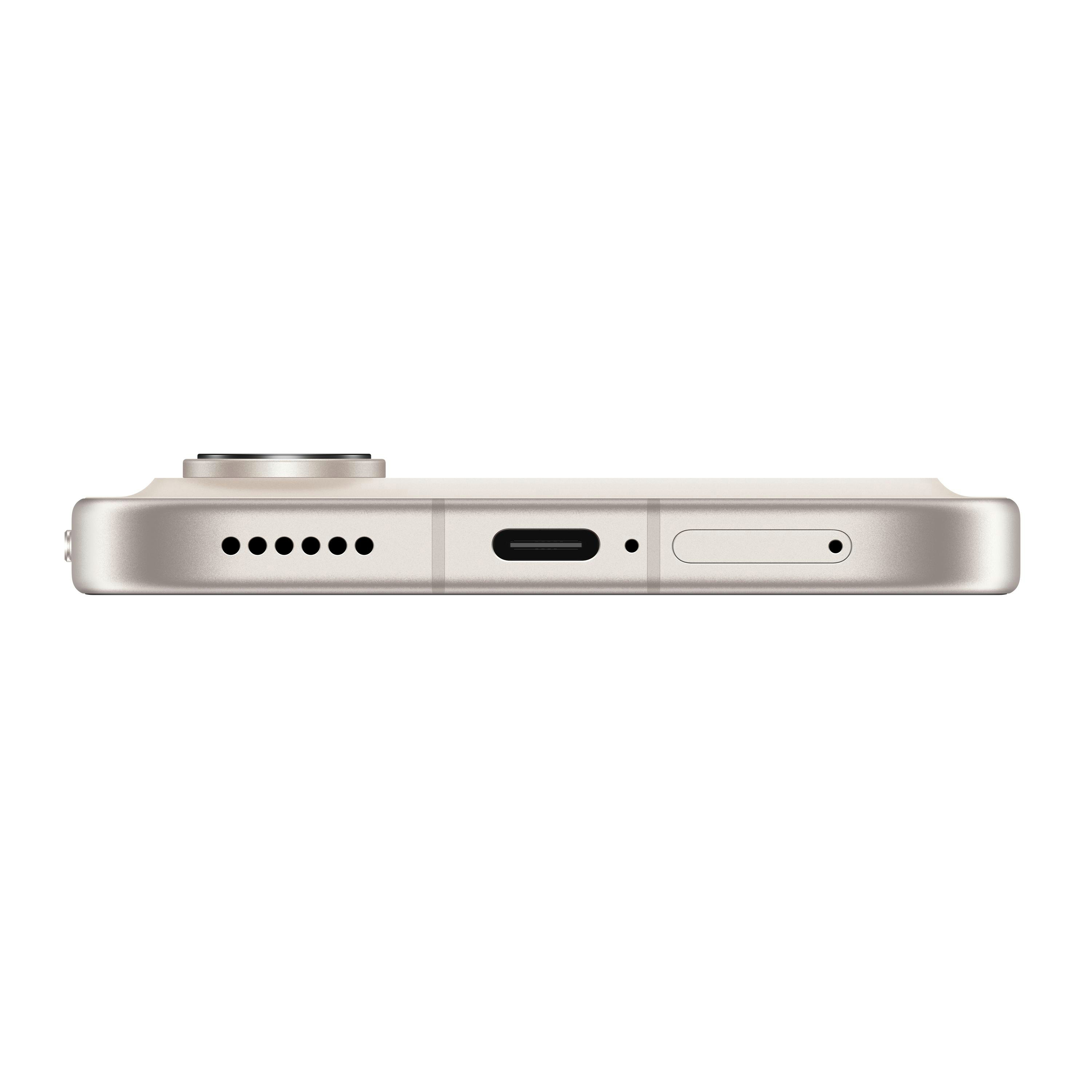 Detailansicht des unteren Rands eines hellbeigen Smartphones mit Ladeanschluss und Lautsprecher.