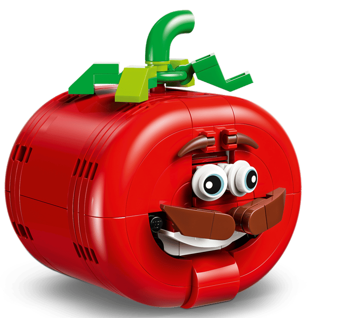 Ein roter Lego-Tomatencharakter mit Augen, Schnurrbart und lächelndem Mund.