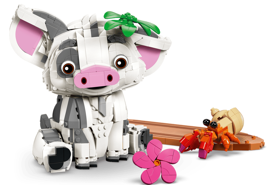 Ein Lego-Schwein mit grüner Blume auf dem Kopf und ein Krabben-Spielzeug.