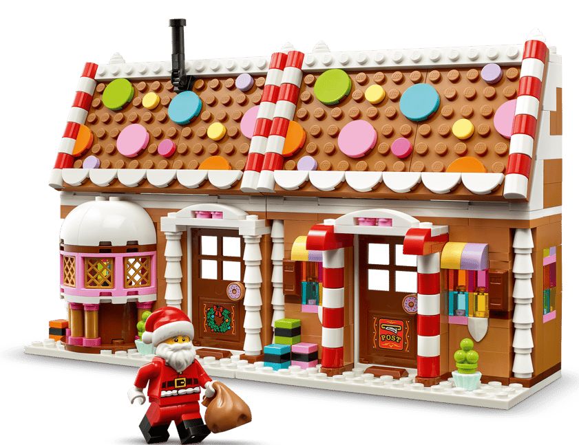 Ein Lego-Lebkuchenhaus mit Weihnachtsmann-Figur und Schneelandschaft.
