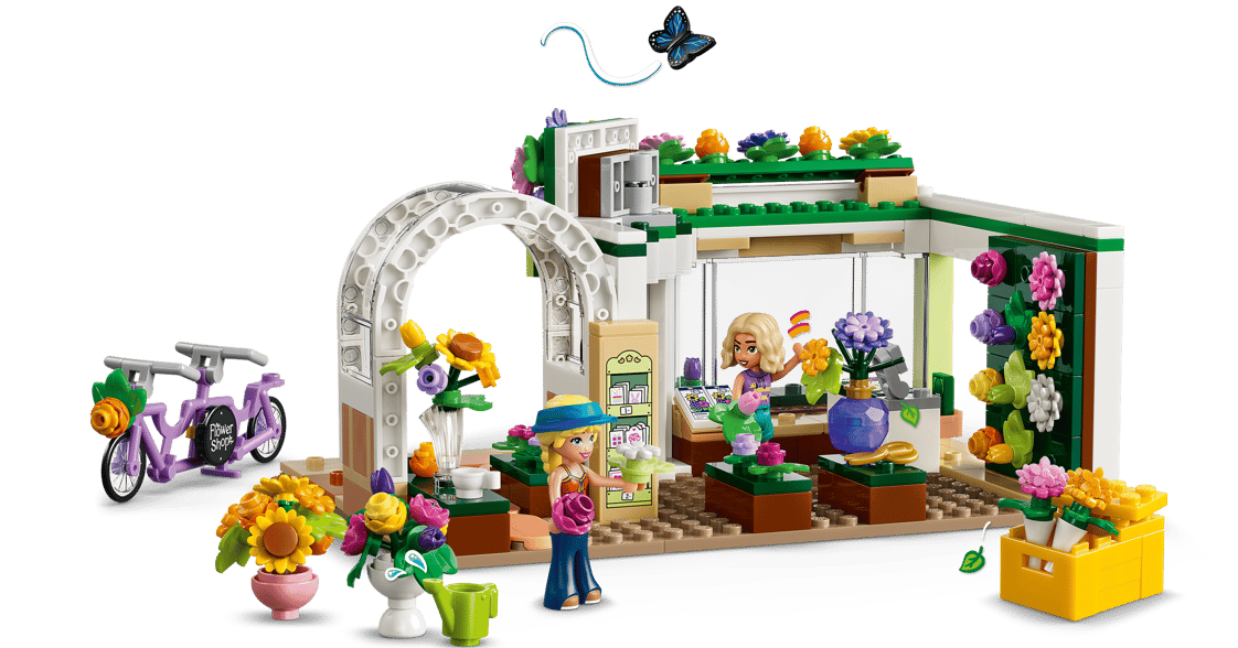 Lego-Blumenladen mit zwei Minifiguren, einem Tandemfahrrad und bunten Blumen.