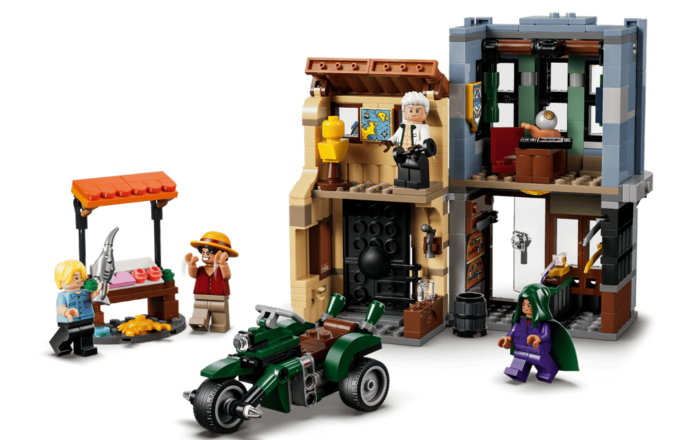 Lego-Szene mit Figuren, Marktstand, Gebäude und Fahrzeug.