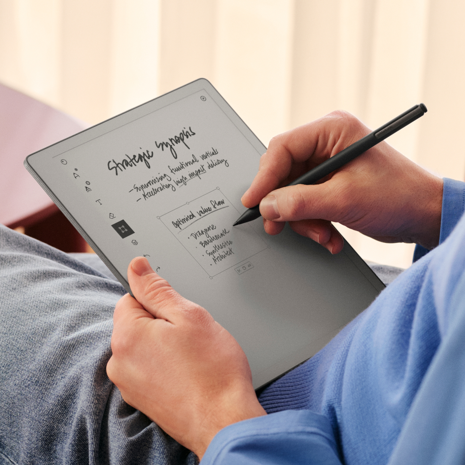 Person writing on e-reader with stylus. Notes: Strategic synopsis, optimized value flow.